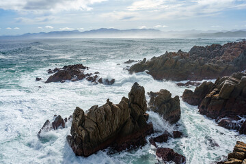 The beautiful coastline at De Kelders with a view across Walker Bay towards Hermanus, Overberg, Western Cape, South Africa.