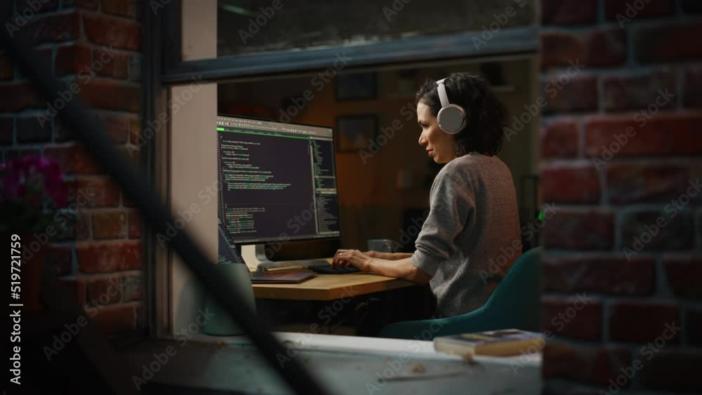 Fototapete Hispanic Female Programmer in Headphones Listening Podcast and Working on Desktop Computer, Screen Shows Coding Language User Interface. Digital Entrepreneur Creating Modern Software.
