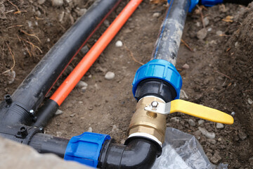 Underground irrigation system with elbow fitting of pvc pipes at bend with yellow tap or faucet