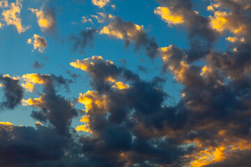 Fototapeta na wymiar Colorful clouds in the blue sky . Cumulus in the morning . Sunlight through the clouds at dawn
