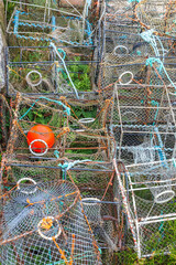 Pile of old lobster traps and orange buoy
