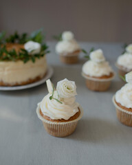 Delicious pastries decorated with flowers and greenery