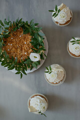 Delicious pastries decorated with flowers and greenery