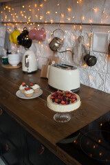 Pastries decorated with berries in the kitchen in a modern interior