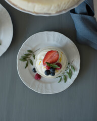 Pastries decorated with berries on a wooden background