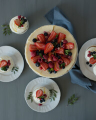 Pastries decorated with berries on a wooden background