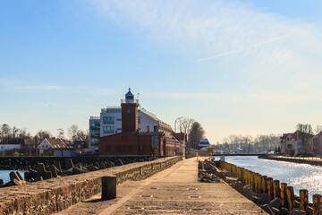 Fototapeta na wymiar Old brick lighthouse at the Wieprza river mouth to the Baltic Sea in Darlowko, Poland
