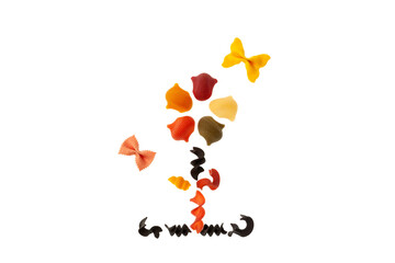 Flower of Multicolored pasta on white background, top view. Design element. Uncooked italian pasta Farfalle
