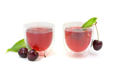 Two transparent glasses with a double bottom filled with cherry juice isolated on a white background.