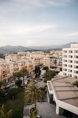 Tropical town in spain close to the ocean & coast with colourful buildings & mountains. 