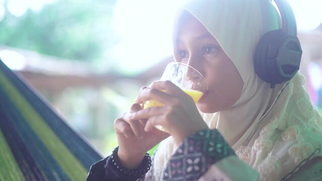 Islamic girl drinking orange juice
