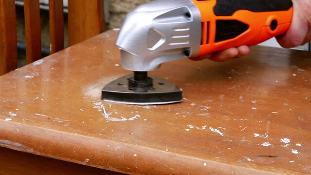 Using a power multi tool to sand old furniture