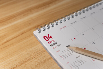 Apr month 2022 Calendar page with pencil business planning concept on wooden background