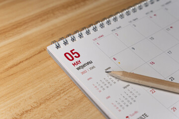 May month 2022 Calendar page with pencil business planning concept on wooden background
