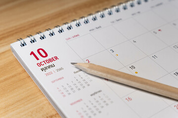 Oct month 2022 Calendar page with pencil business planning concept on wooden background