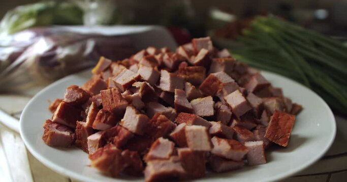 Many pieces of pork jerky put on a plate. Closeup.
