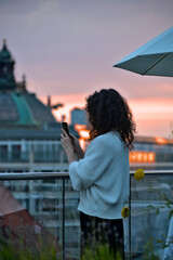 pretty young woman photographing a skyline