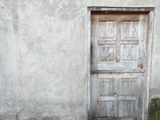 A wooden double door with copy space area on the left