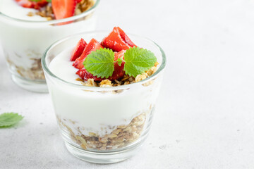 Healthy low calorie strawberry granola greek yogurt dessert. Top view, copy space,flat lay.