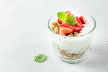 Light refreshing strawberry granola greek yogurt dessert. Top view, copy space,flat lay.