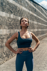 A young woman catching her breath after a running session