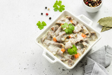 Slow cooker creamy chicken gizzards, giblets, offal. Top view, copy space.