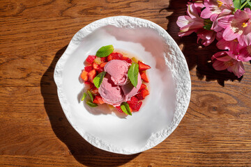 Strawberry ice cream with strawberries and fresh mint