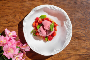 Strawberry ice cream with strawberries and fresh mint
