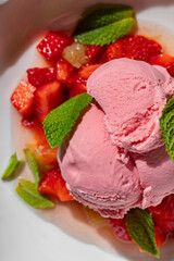 Strawberry ice cream with strawberries and fresh mint