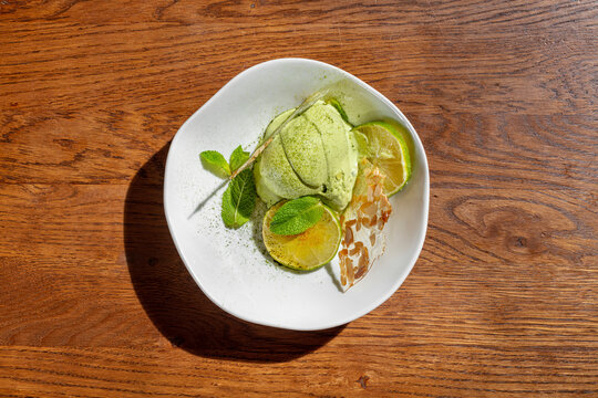 Lime ice cream with lime wedges and mint.