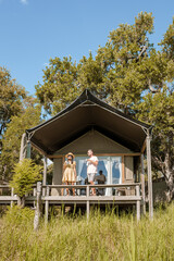 couple on safari in South Africa, Asian women and European men at a tented camp lodge during the...