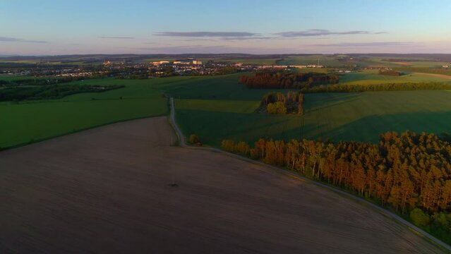 Quiet summer evening road to the city on the horizon leading through the woods and fields - Svitavy, Czech Republic
