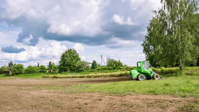 Timelapse. Mini skid steer loader clear the construction site. Territory improvement land work. Small tractor with ground leveler move soil and turf. Agriculture machine. Creation of landscape design.