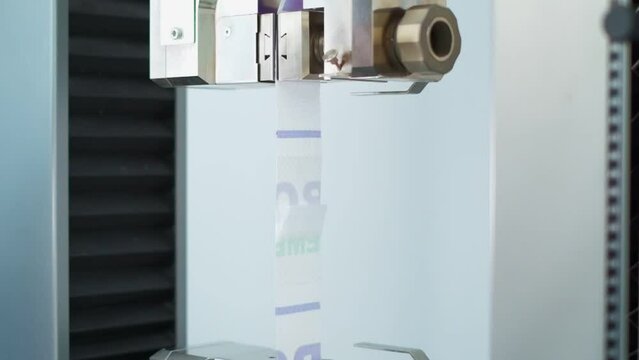 Polymer thread sample tape for plastic sack bags is tested for strength in laboratory
