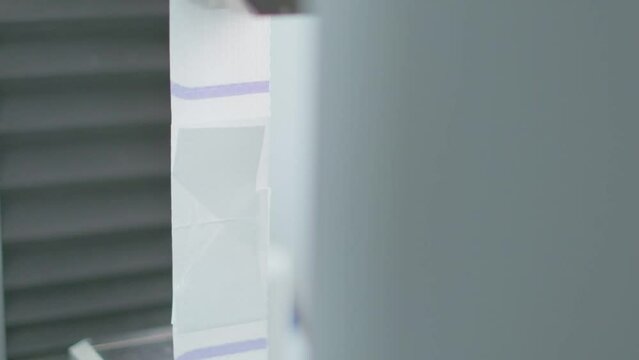 Polymer thread sample tape for plastic sack bags is tested for strength in laboratory