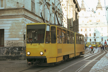 Fototapeta na wymiar Yellow tram in Lviv city in sunny day