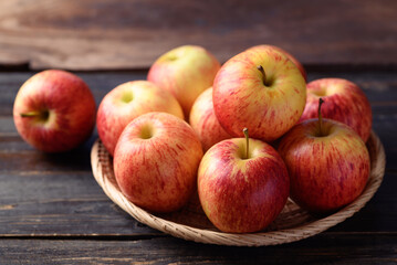 Fototapeta na wymiar Red apple fruit in basket on wooden background, Healthy fruit