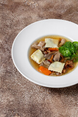Mushroom soup with rabbit ravioli