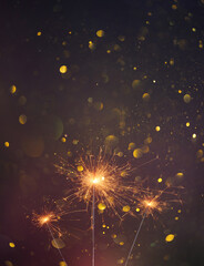 Happy New Year, Sparklers burning bright with shiny sparks and bokeh festive silvester party...