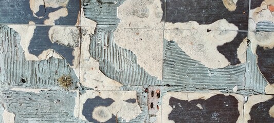 An old peeling tile wall. Abstract texture background. Banner.