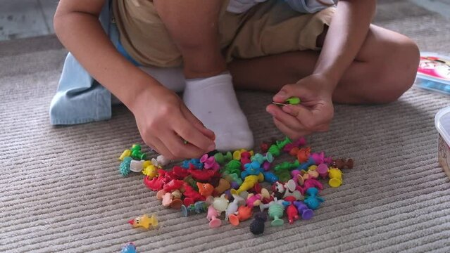 Little toddler boy playing with colorful plastic toys at home creative game, imagination