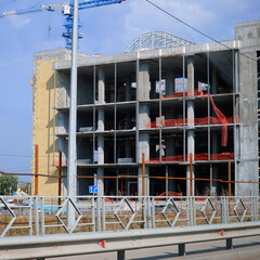 Fototapeta na wymiar Construction crane at Unfinished building under construction