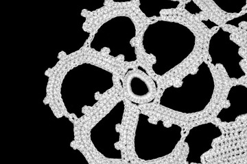 White crochet texture isolated on black background.