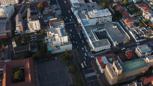Real fire truck driving fast through city road. Emergency services and ambulance red cars with first responders. Aerial shot in Cape Town South Africa.