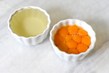 Separated yolk and egg white prepared for baking  