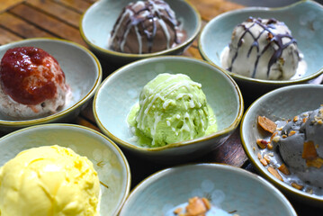 Organic ice cream in bowls on wooden background closeup