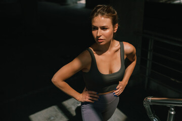 Portrait of female jogger in sportswear resting during her workout. Healthy habits.