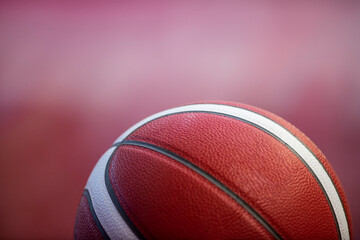 Professional basketball ball on the parquet with black background. Horizontal sport theme poster, greeting cards, headers, website and app.