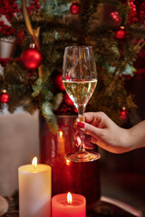 A man holds a glass of champagne