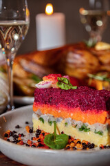 Pie with potatoes, herring, carrots, egg, beets and basil